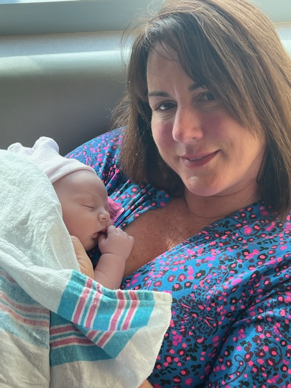 Intended parent Kelly holds her new baby boy.