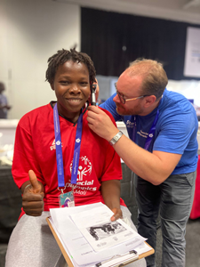 Starkey Cares volunteer Kim Fredrik Haug (right) is shown with Special Olympics athlete Safiatou Konare from Mail (left).
