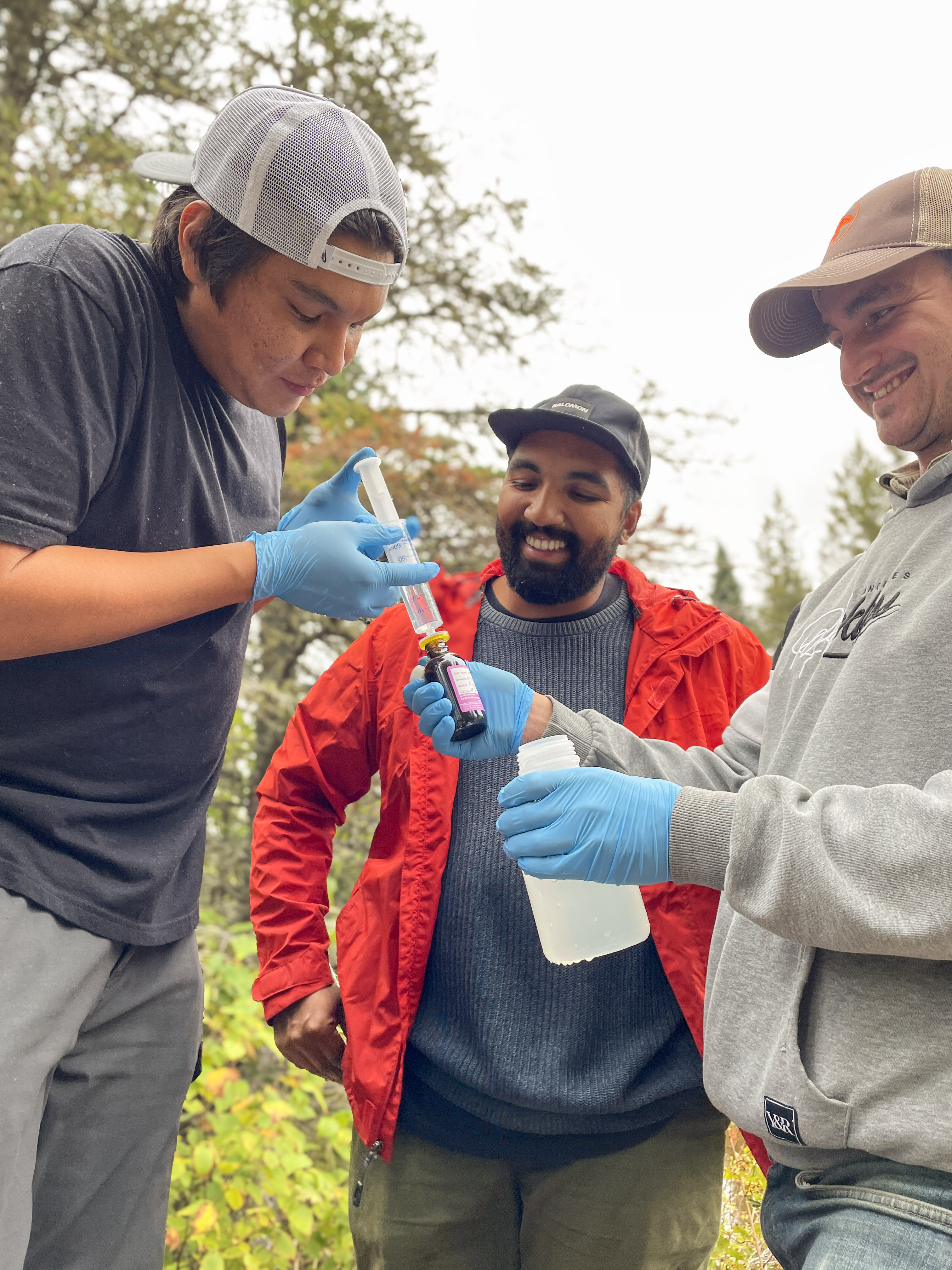 Water First interns and staff practice proper water sampling techniques to ensure accurate field data collection