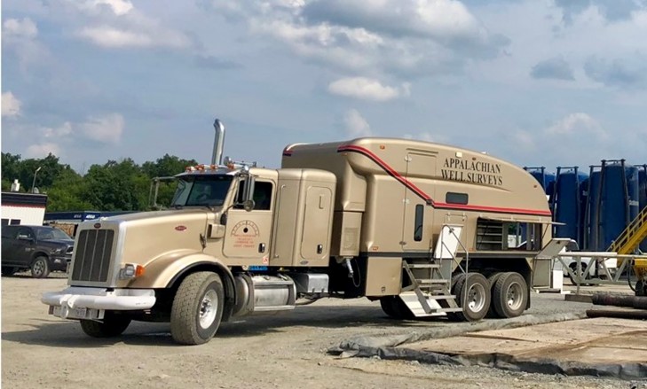 An Appalachian Well Surveys, Inc. mast truck operating on a recent jobsite.