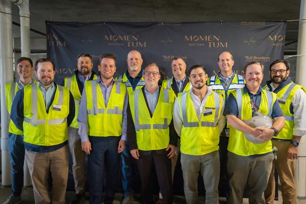 Senior executives and development team members from Toll Brothers Apartment Living, PGIM Real Estate, and Balfour Beatty were joined by Atlanta City Councilmember Matt Westmoreland for the topping-out celebration of Momentum Midtown.