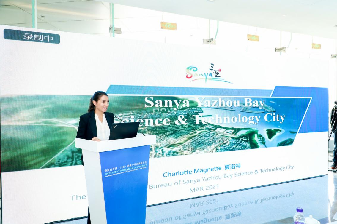 Charlotte, the International Investment Manager, actively promotes the Science and Technology City to guests in English.