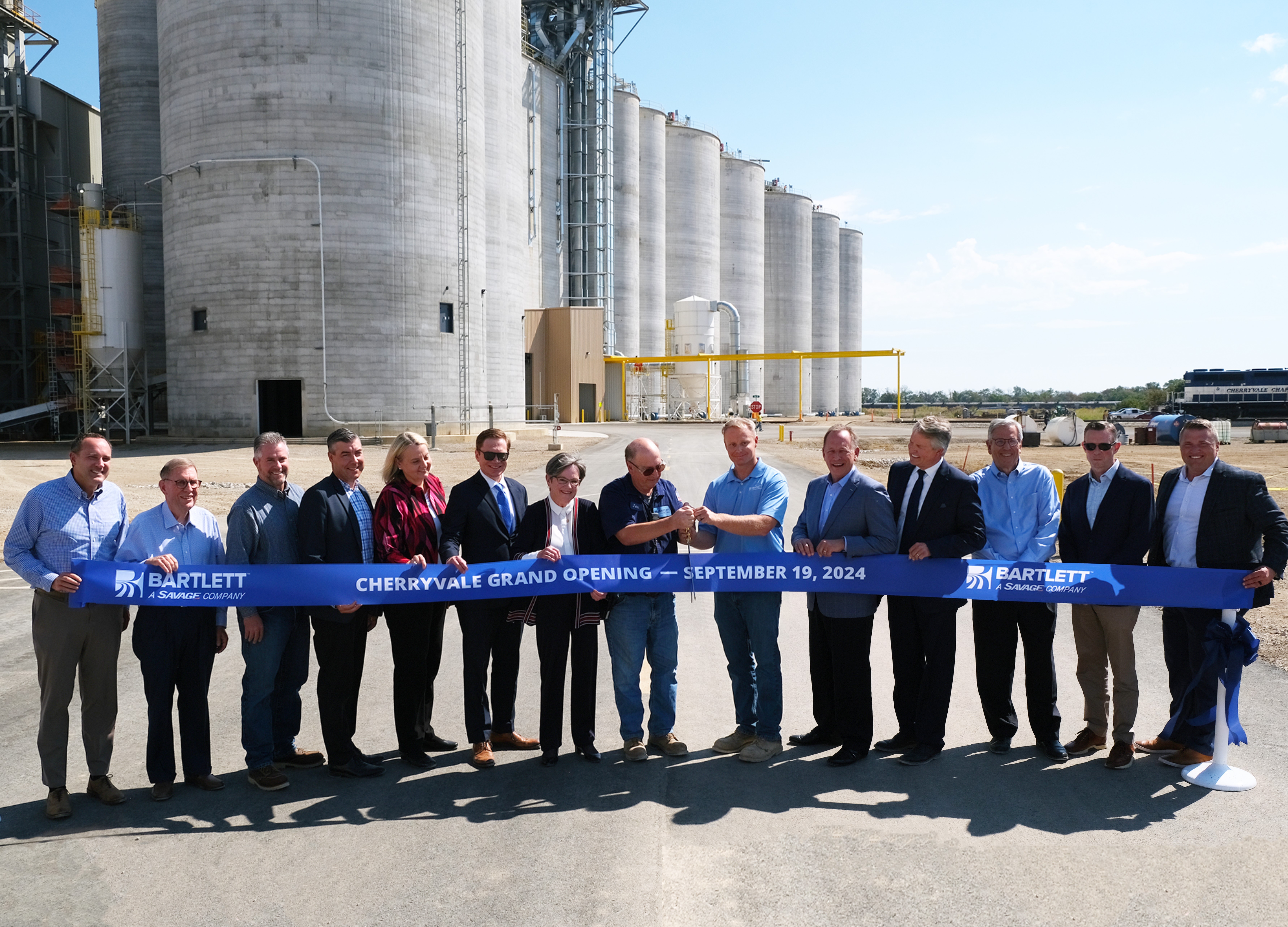 Ribbon cutting at the September 19, 2024 grand opening celebration for Bartlett's new soybean processing plant in Cherryvale, KS, with Bartlett and Savage leaders joined by federal and state officials