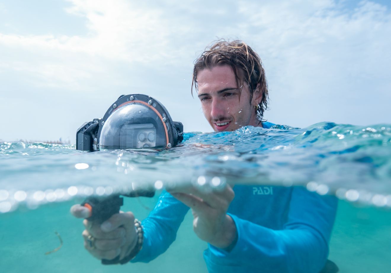 Snorkeler using DIVEVOLK AquaLock dome lens at surface