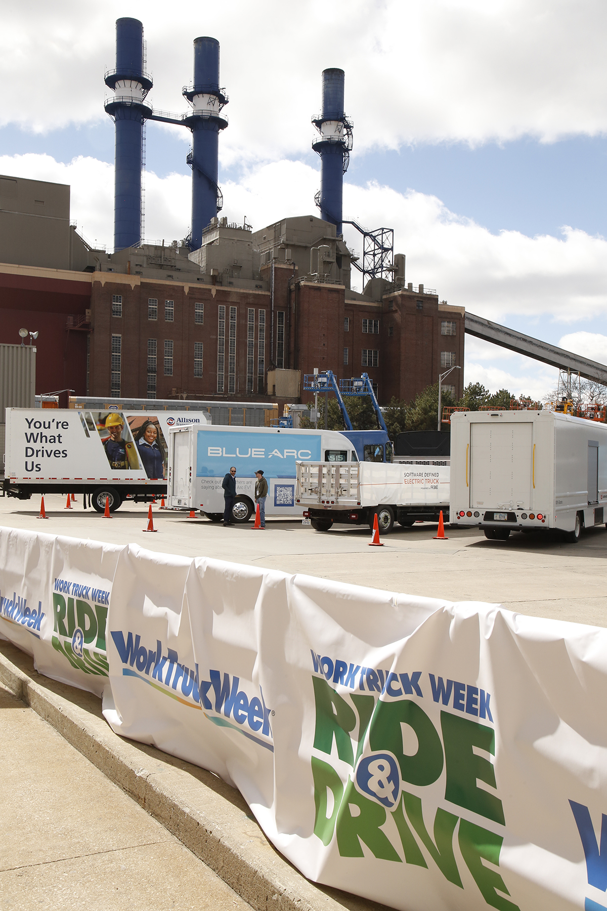 commercial vehicles with the latest technology, fuel and propulsion systems behind banners that say Work Truck Week Ride & Drive