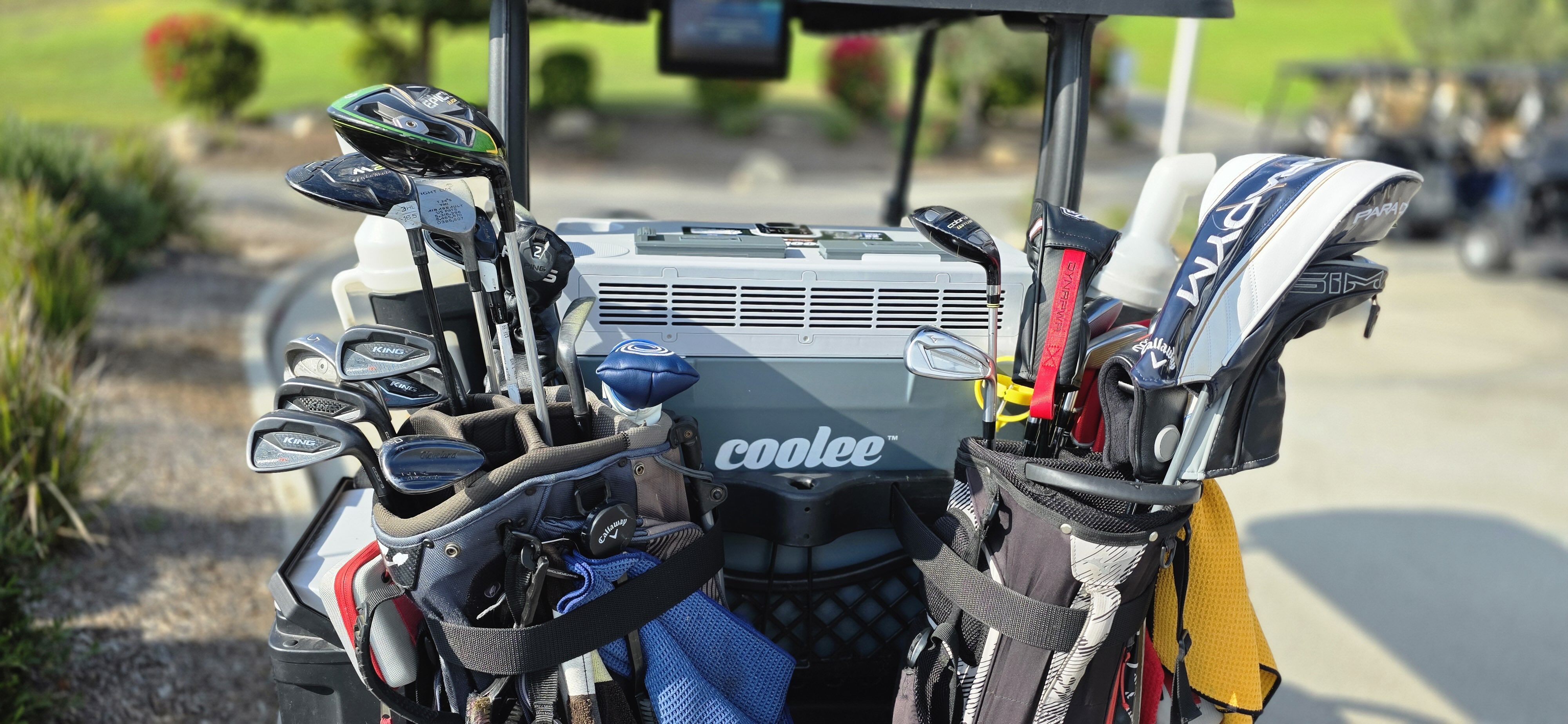 Rear view of the Cool Boss by BendPak Coolee Tour LX portable air conditioner in a golf cart’s rear basket.