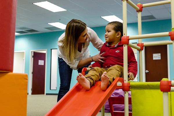A member of InBloom's clinical team provides therapy during play time at one of InBloom's Learning Centers.