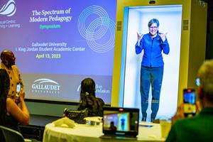 President Roberta J. Cordano of Gallaudet University beams in to the Visual-Centre Teaching & Learning Symposium as a hologram in the Proto Epic. It is the first time American Sign Language has been used via hologram in a higher education sett8ing. “This is a dream come true for me personally and for the deaf community. For so long, we have been eager to utilize ASL and English bilingualism through hologram technology, which allows us to fully express ourselves in ASL, a spatial language.” said Dr. Laurene E. Simms, Gallaudet University’s first Chief Bilingual Officer. Photo by Matthew Vita.