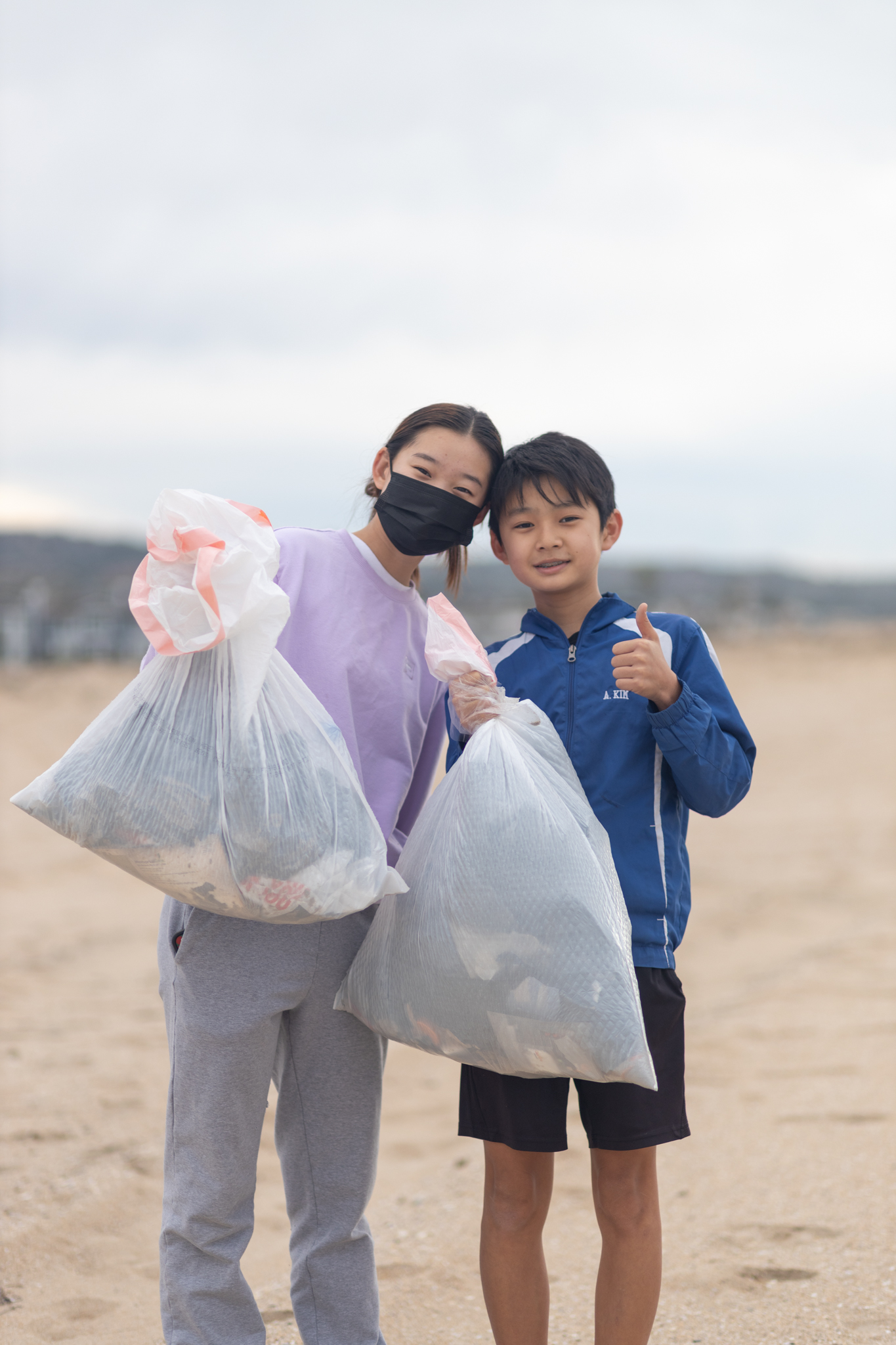 Kids cleaning up the beach near Balboa Pier