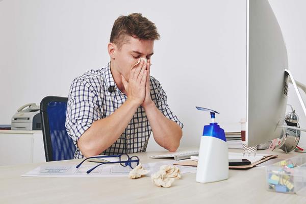 Office worker sick at his desk