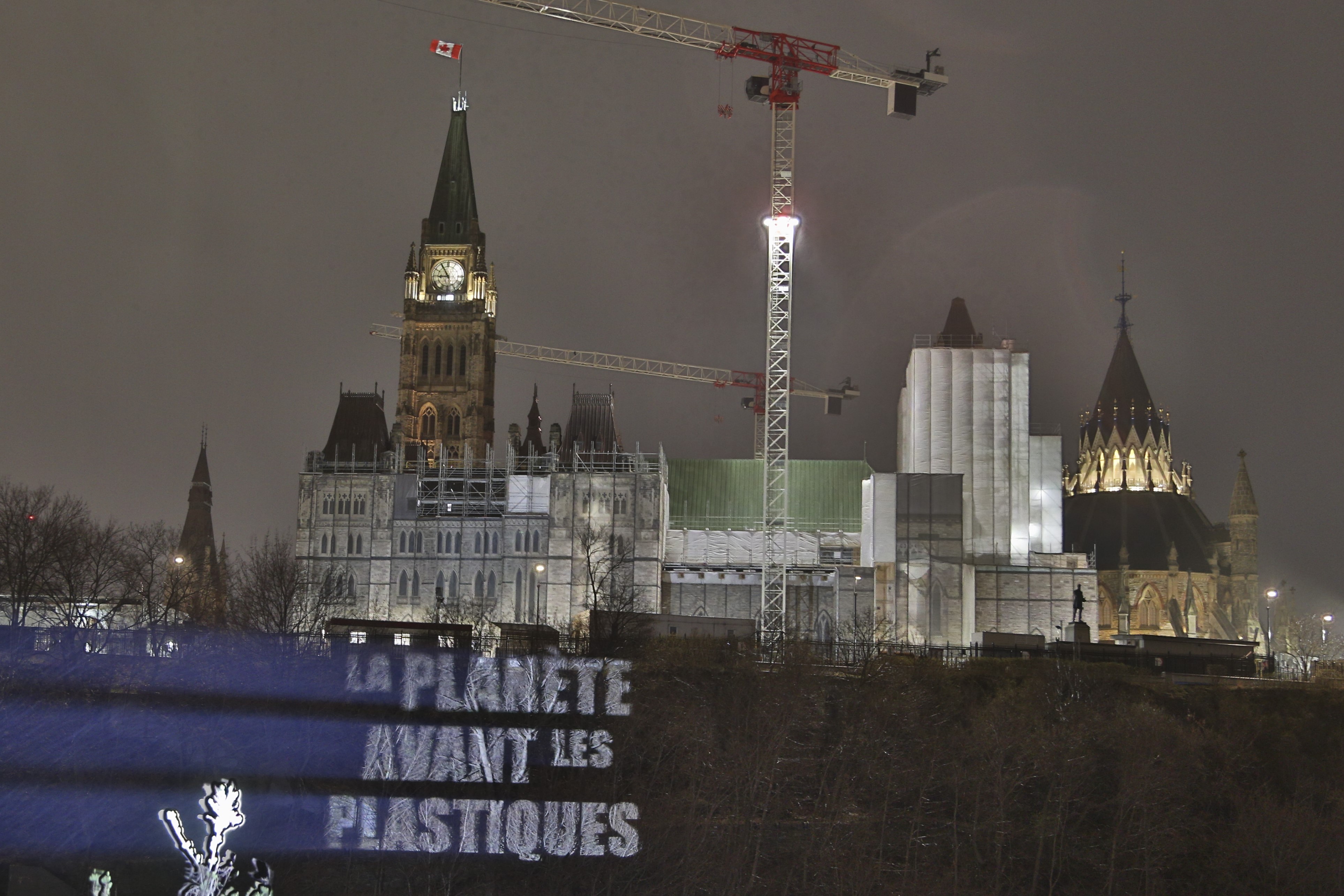 “La Planète Avant Les Plastiques” is projected on Parliament Hill, on Monday, April 22, 2024 by Oceana Canada and EARTHDAY.ORG. The illuminated message urges global leaders to negotiate a strong, legally-binding treaty to end plastic pollution.