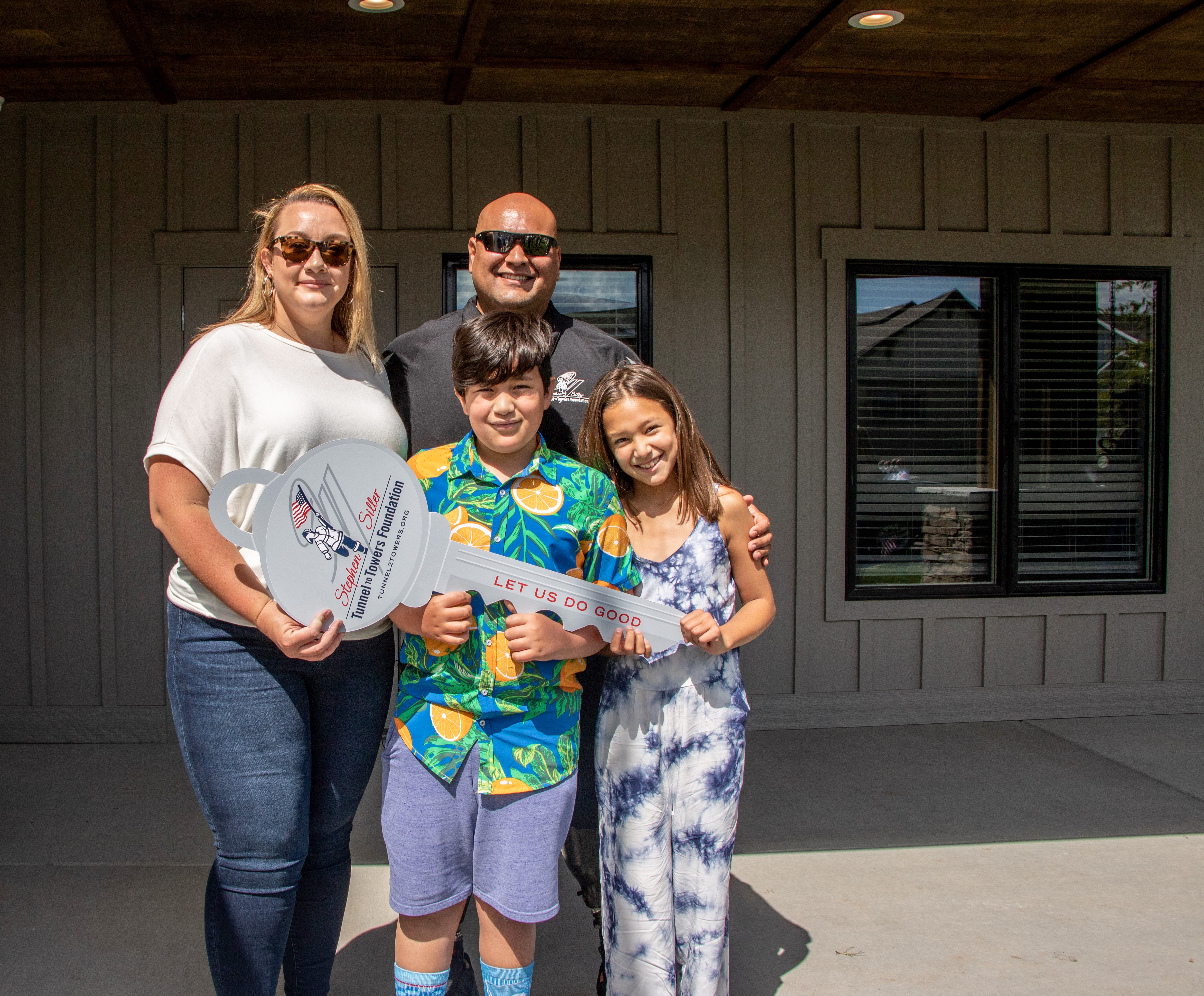 SGT Saul Martinez and his family outside of their new smart home in Bozeman, Montana