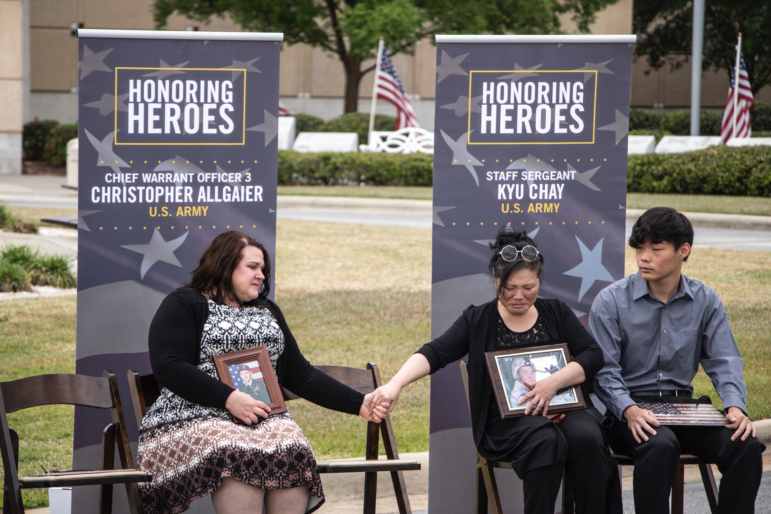 Jennifer Allgaier comforts Cathy Chay during the Tunnel to Towers ceremony honoring their husbands, Army Chief Warrant Officer 3 Christopher Allgaier and Army Staff Sergeant Kyu Chay at the U.S. Army Airborne & Special Operations Museum, in Fayetteville, North Carolina. 