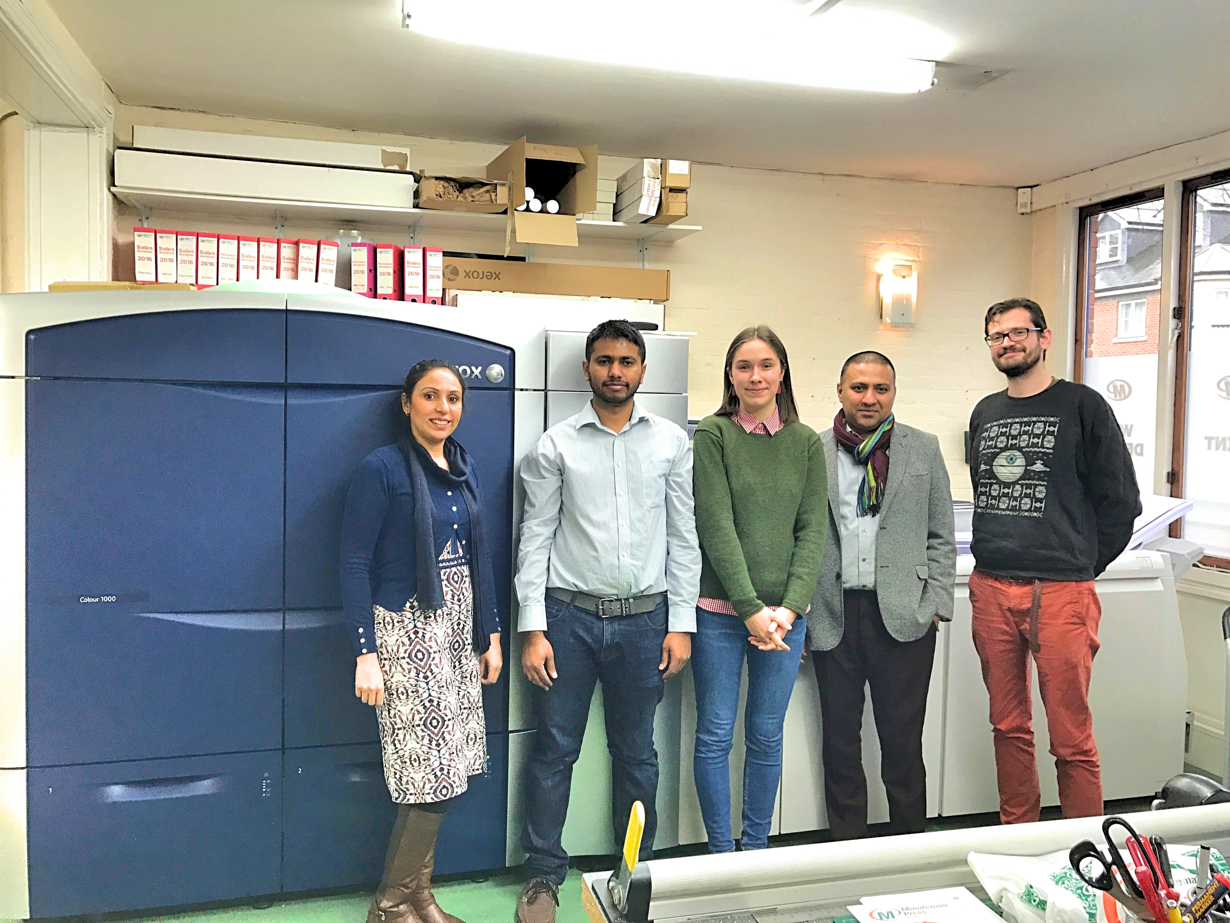 Amad Hassan (2nd from right) owns the Minuteman Press design, marketing, and printing franchise in Oxford, England.