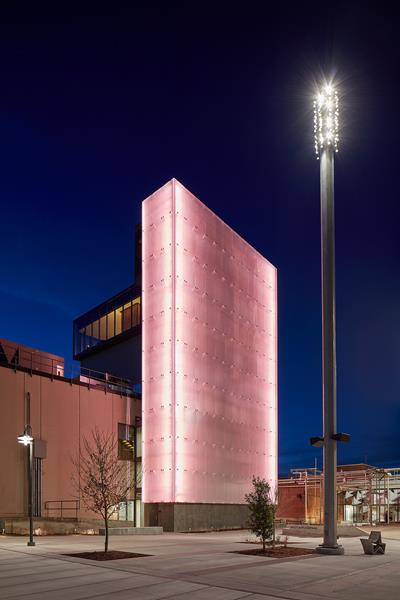 Among The Momentary’s most striking new architectural features is an 80-foot-tall projectable glass rainscreen by Bendheim. Illuminated at night, it becomes a beacon on the site. Photo courtesy of The Momentary, Bentonville, AR.