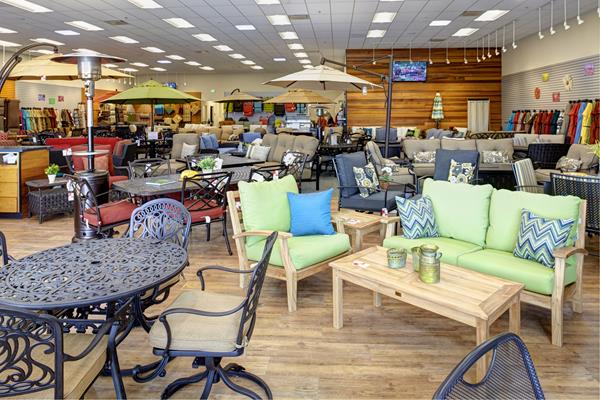 Image shows many patio furniture sets and accessories in a Christy Sports store showroom