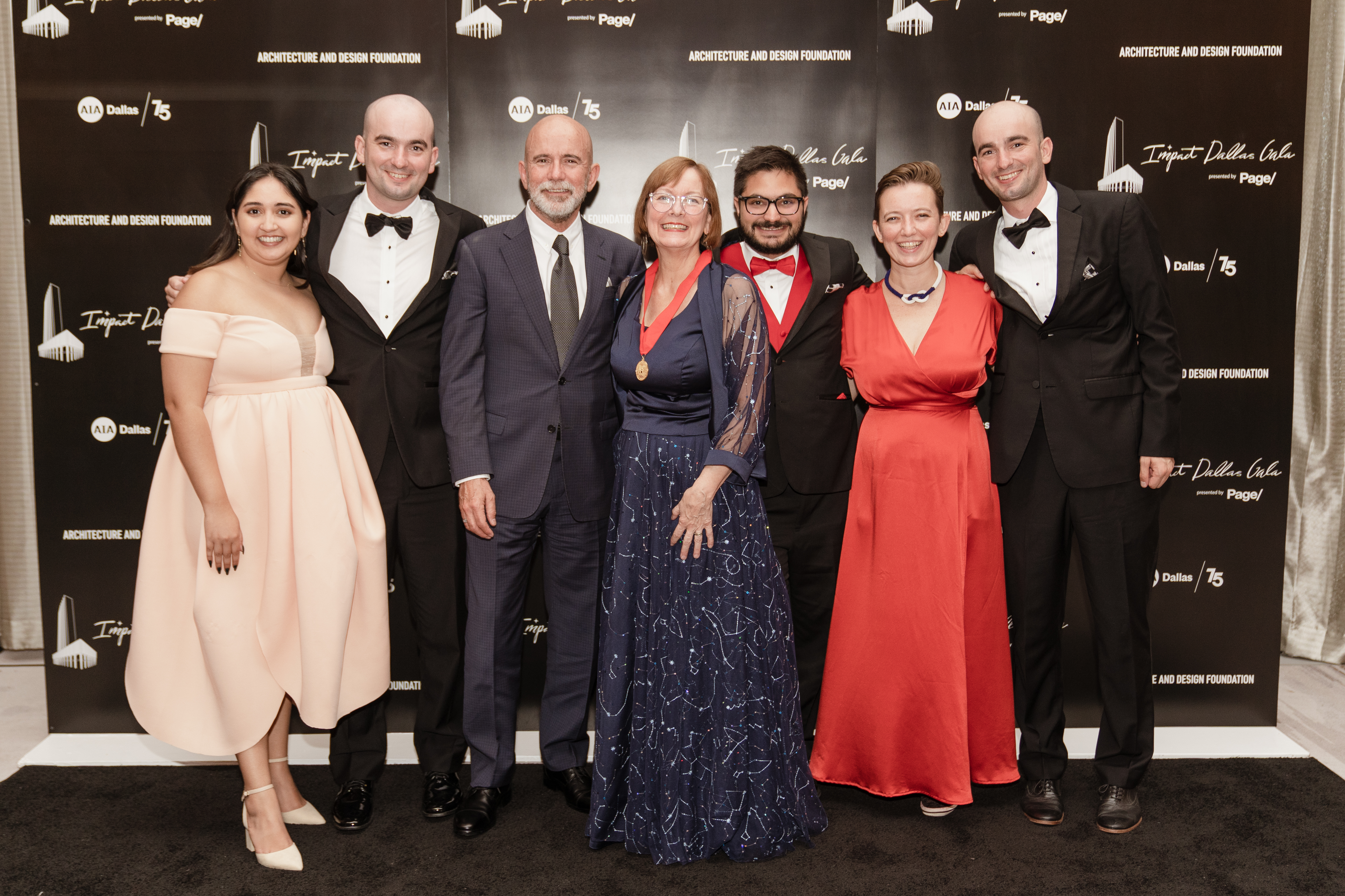 AIA Dallas' 2022 Lifetime Achievement award winner Betsy Del Monte, FAIA (center) and her family (credit Menary Studio)