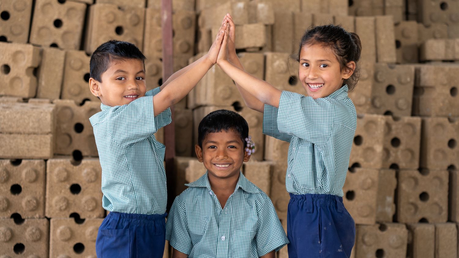 Students at Kopila Valley School pose with the compressed earth bricks prepared for the construction of the new Kopila Valley Children's Village.