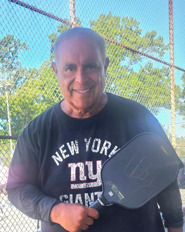 A man using HUDEF's Apex Pro2 Pickleball Paddle during a game