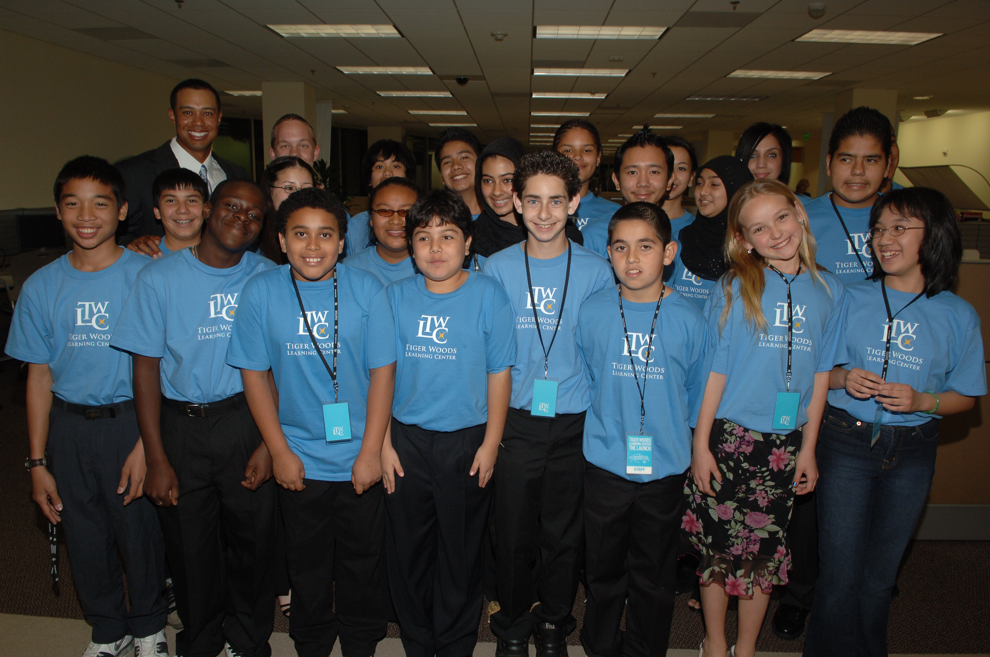 After cutting the ribbon to open the flagship TGR Learning Lab Anaheim, formerly Tiger Woods Learning Center, in 2006, Tiger gathers with students in attendance.