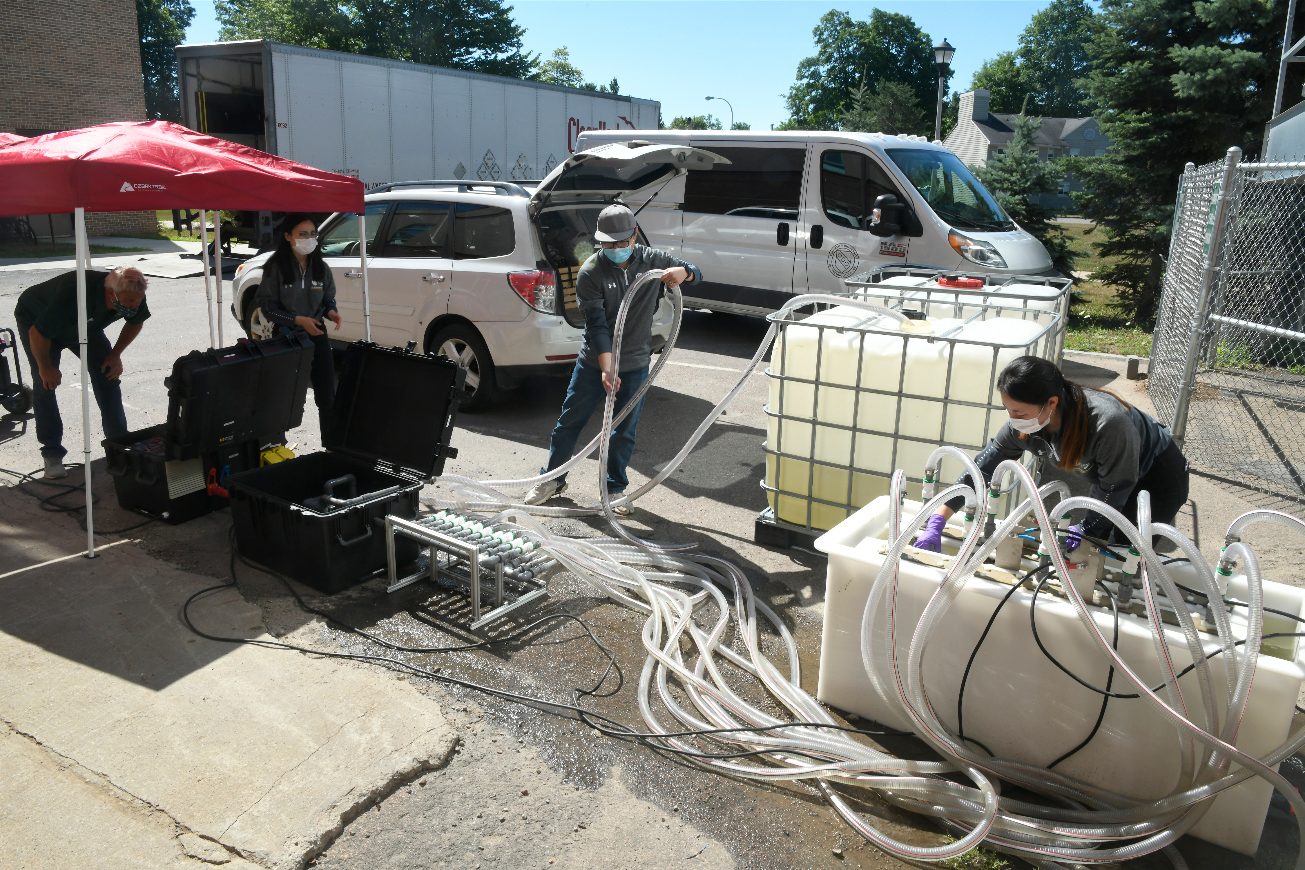 Clarkson students and Professor Yang Yang decontaminate lake water using a HAB Terminator on campus.