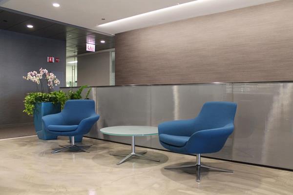 Metallic laminated glass becomes the backdrop for this seating area.