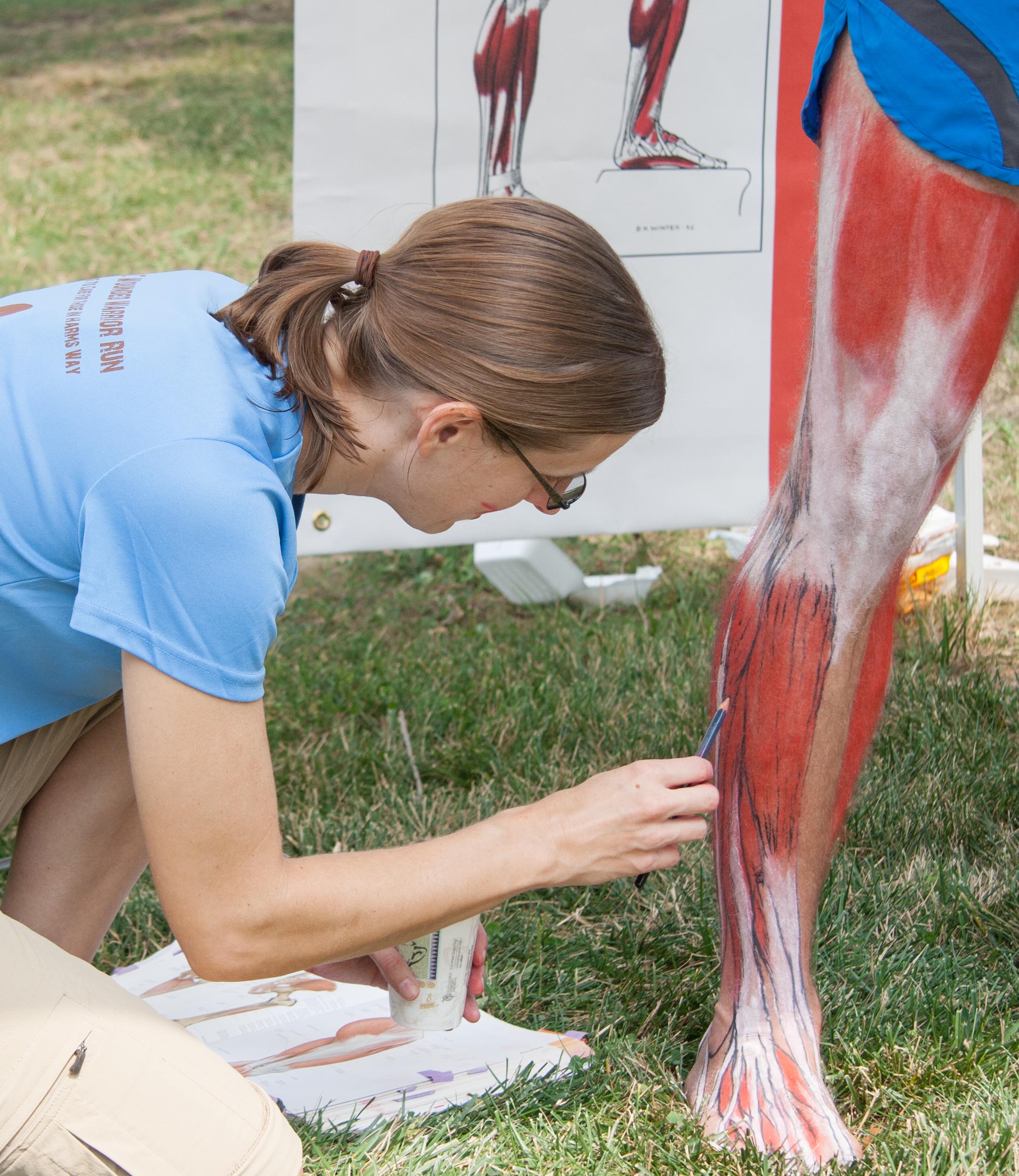 Elizabeth Weissbrod, an HJF employee working as a medical illustrator with the Uniformed Services University Val G. Hemming Simulation Center, highlights the muscles of the leg and foot as part of the Anatomy of Sports program held on August 9, 2014 at the National Museum of Health and Medicine (NMHM) in Silver Spring, Md.