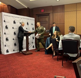 U.S. Marine Corps Colonel Paul Gillikin, Program Manager, Combat Support Systems (CSS) addresses the WPRC members