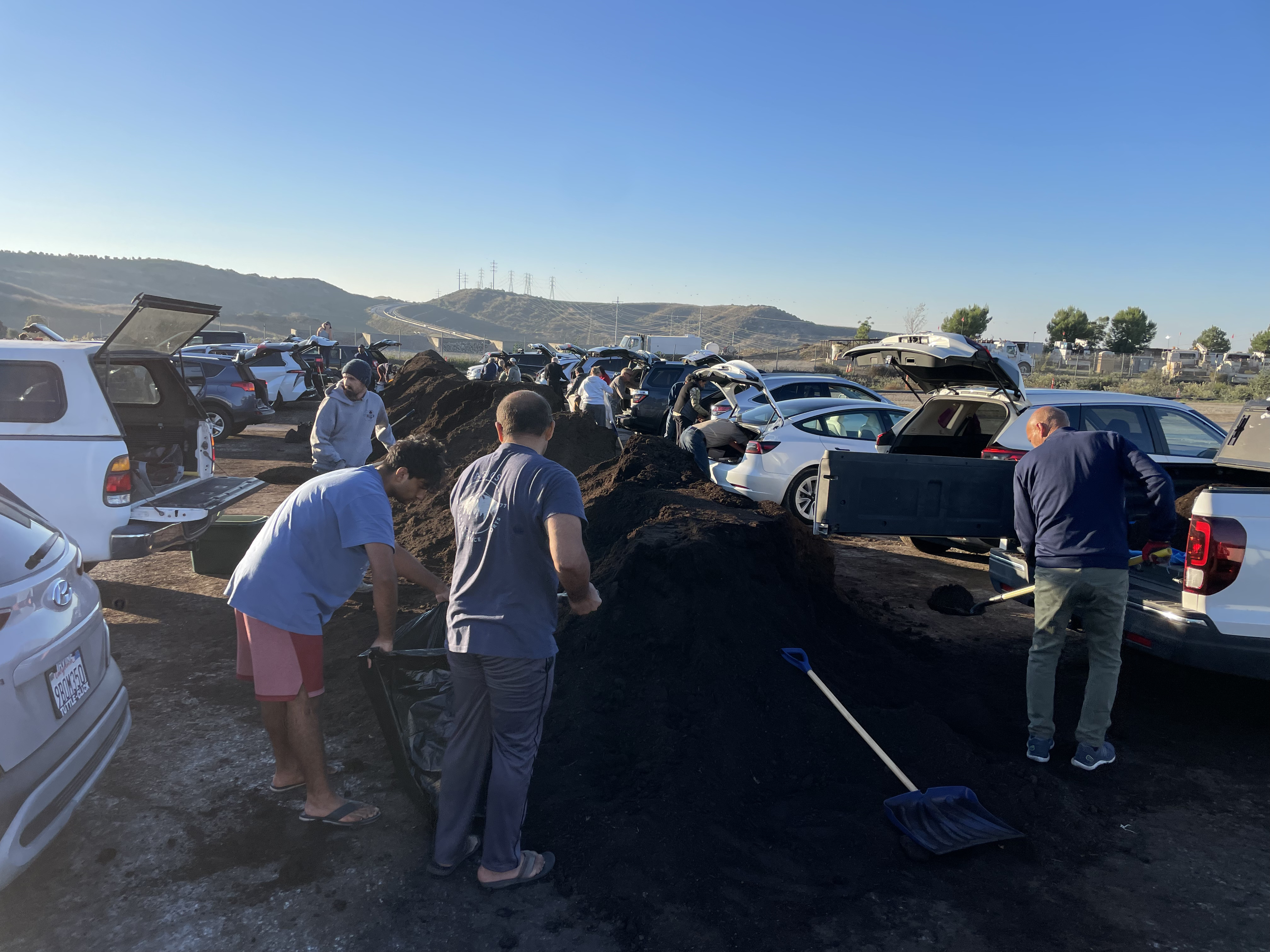 Orange County residents shoveling up their scoop of free compost.