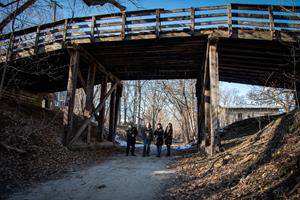 Advocates from the W.A. McConnell Foundation  stand under the historic Richmond Bridge in Richmond, Illinois, included on the 2023 Most Endangered list. Since including the bridge on the Most Endangered list, the Village has taken steps to repair and preserve the bridge.
