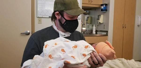 Michael Bise, of Wyoming, holding his newborn daughter weeks after undergoing a lifesaving double lung transplant at Dignity Health St. Joseph's Hospital and Medical Center in Phoenix.