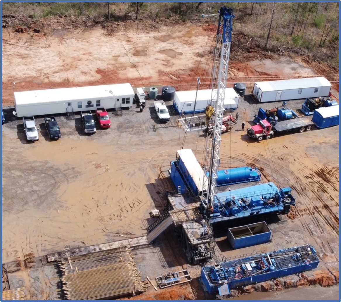 Drill rig at the Beulah-Taylor #1 well re-entry site in Lafayette County, Arkansas.  This reused a pre-existing drill pad (note existing powerline running through the wellpad area).  The drill rig has since demobilized from this location after reaching a total measured depth of 8,940 ft,and has been replaced by a workover rig to complete perforations, final testwork and sampling.