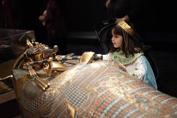 Young girl celebrates the opening of 'Tutankhamun: His tomb and His Treasures
