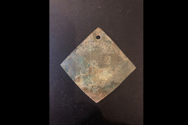 The 1853 slave badge recently discovered on the College of Charleston campus