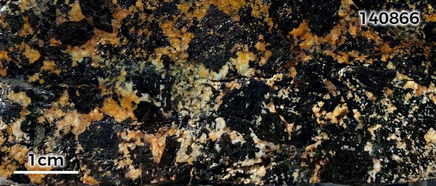 Sample 140866: Coarse-grained, malachite-azurite stained hornblende gabbro. Sample returned an assay of 0.63% Cu.