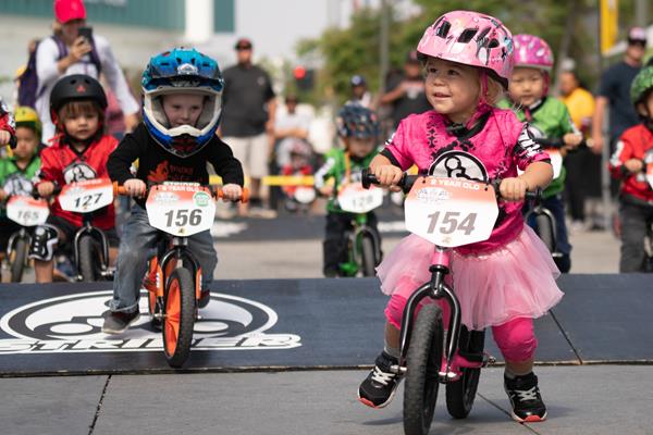 2-year-old racers dash out of the start gate on their Strider Balance Bikes at the May 4, 2019   Strider Cup in Los Angeles, CA. 