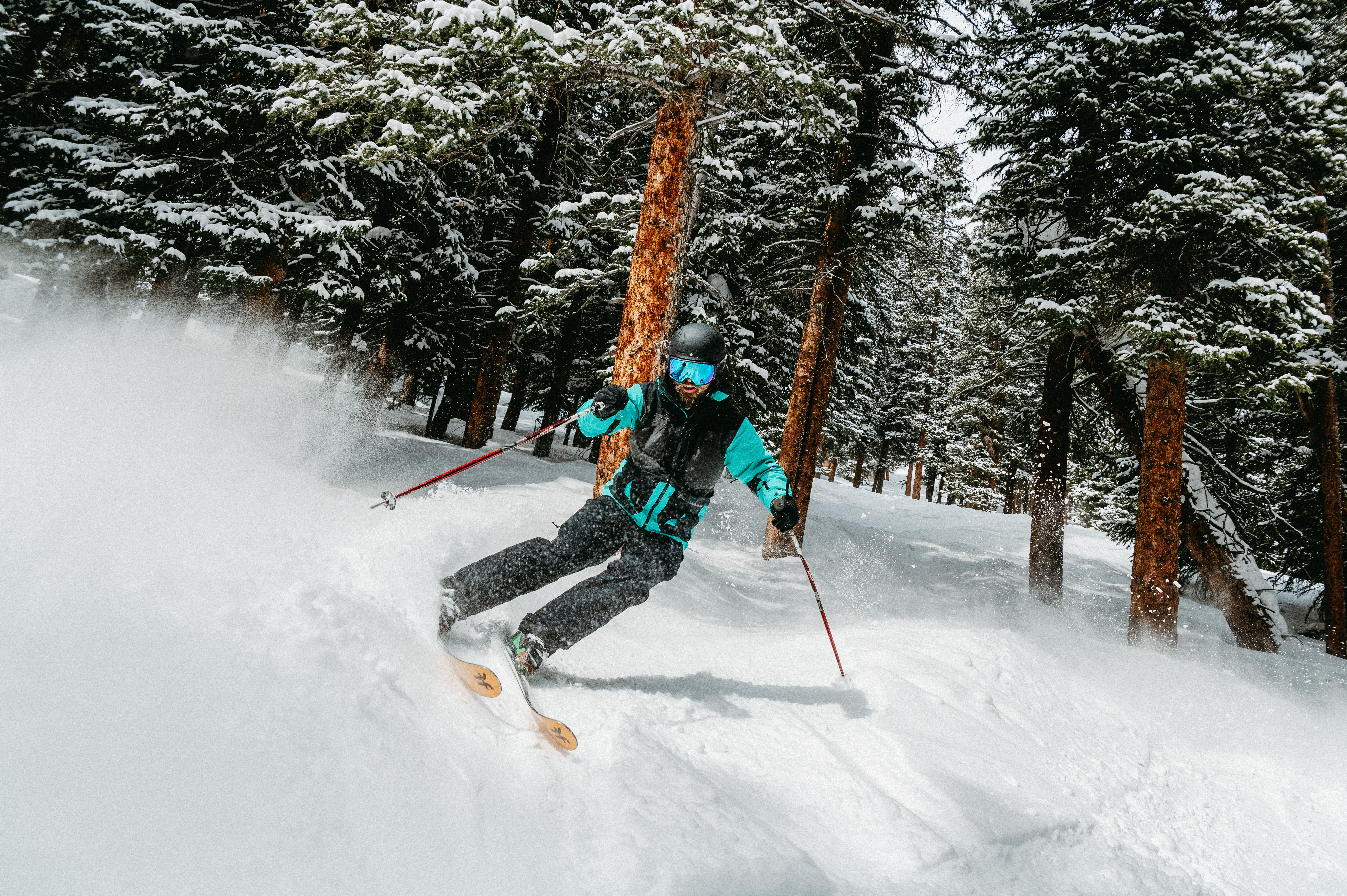 Man skiing down the ski slopes in gear and apparel from Christy Sports.