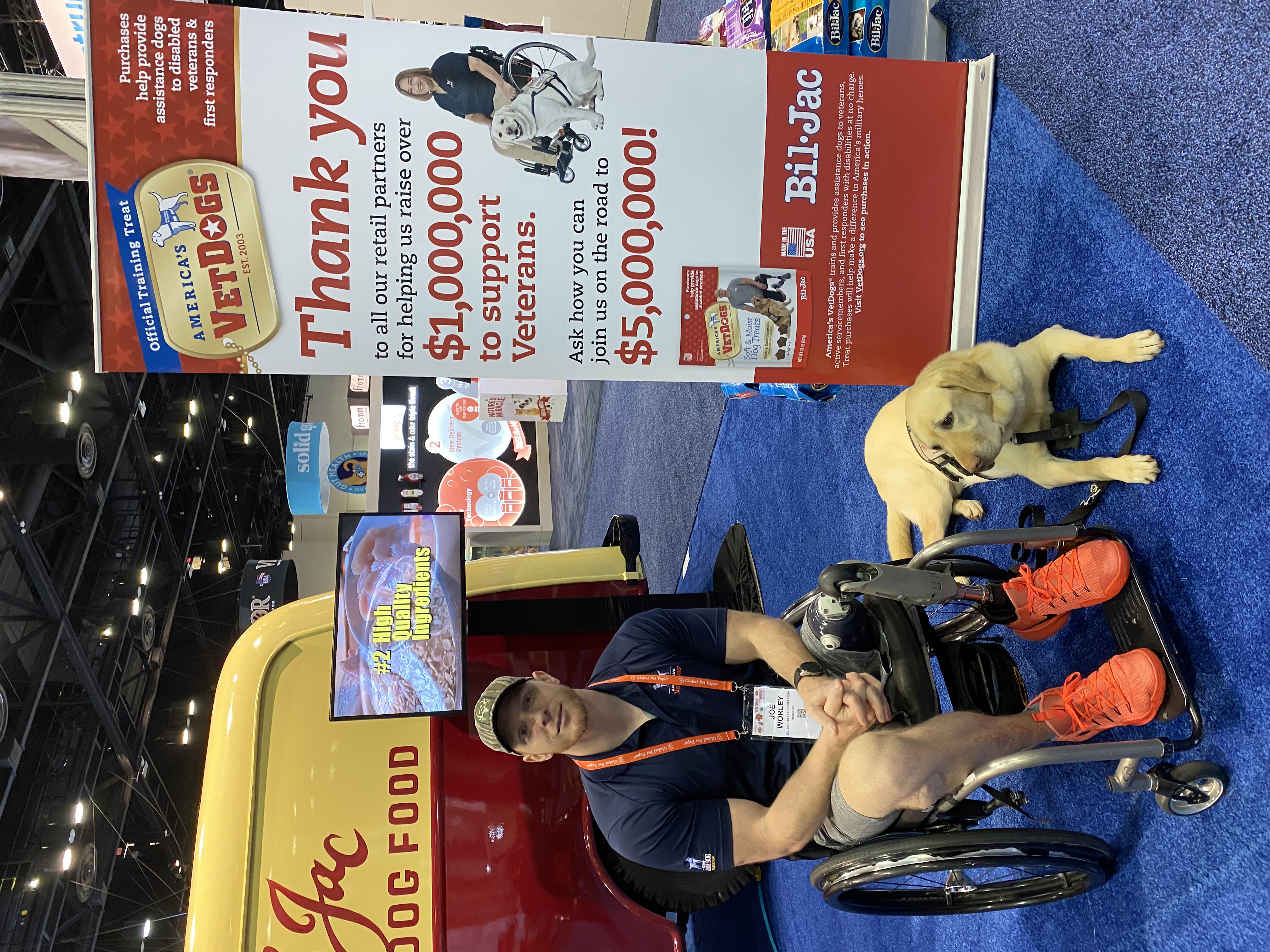 U.S. Navy Veteran and America's VetDogs client Joe Worley with service dog Galaxie at Bil-Jac's exhibit at Global Pet Expo in Orlando, Florida 2019. 