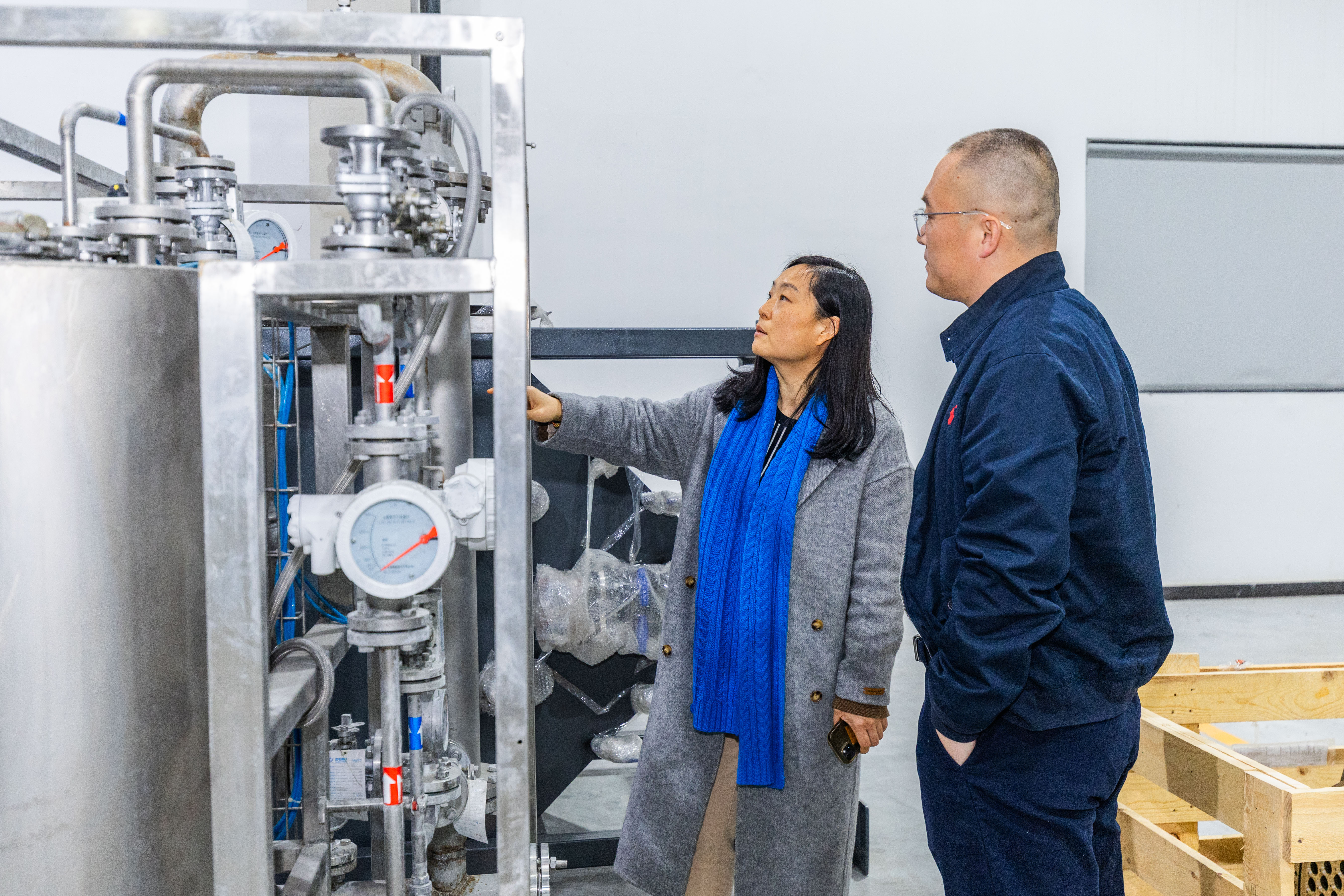 Jitri LiqTech engineers inspect components of a silicon carbide membrane water-treatment system at the Haimen facility, designed for marine applications.