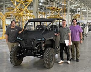 Members of Volcon's engineering and manufacturing team in front of a Stag production unit at GLV manufacturing facility.