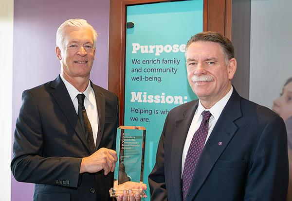 Ira Gottshall (L), President and CEO of FFP Insurance Services, receives the 2018 Community Involvement Award from Jim Boyle (R), President and CEO of Foresters Financial.