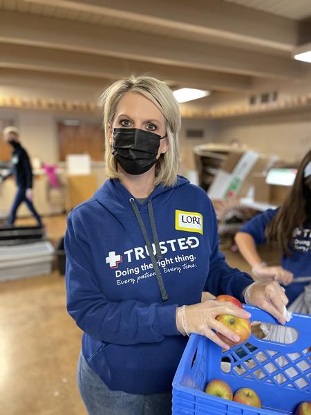 Trusted Medical co-founder and CEO, Lori Guerrero, sorts food items at Community Table food pantry in North Richland Hills on MLK National Day of Service as part of a nationwide effort to honor the legacy of Dr. Martin Luther King Jr. 