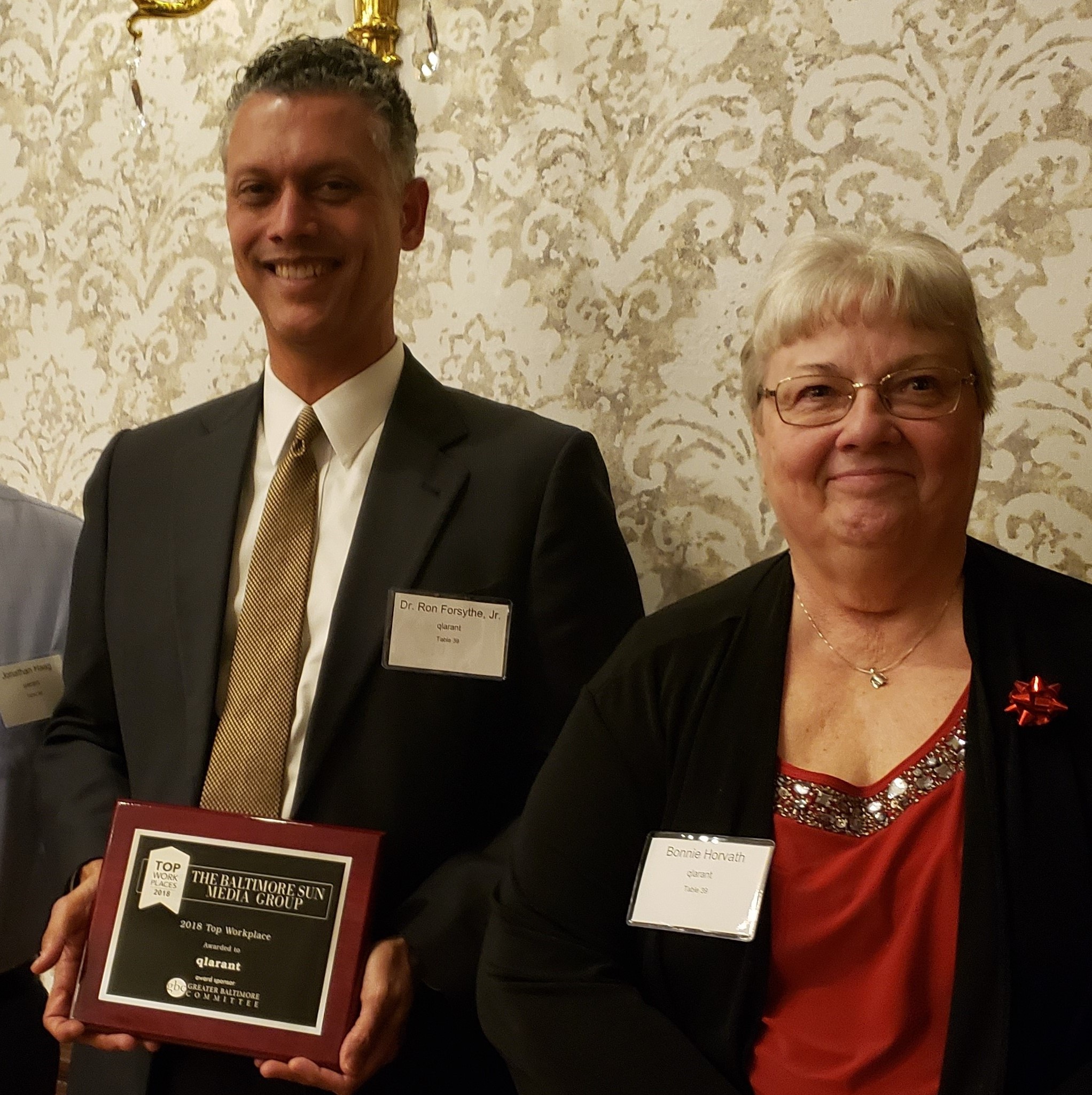 Ron Forsythe, Jr. Phd  CEO of Qlarant 
and Ms. Bonnie Horvath Program Director for Qlarant accept the Top Places to Work Award as a 3 time winner. 