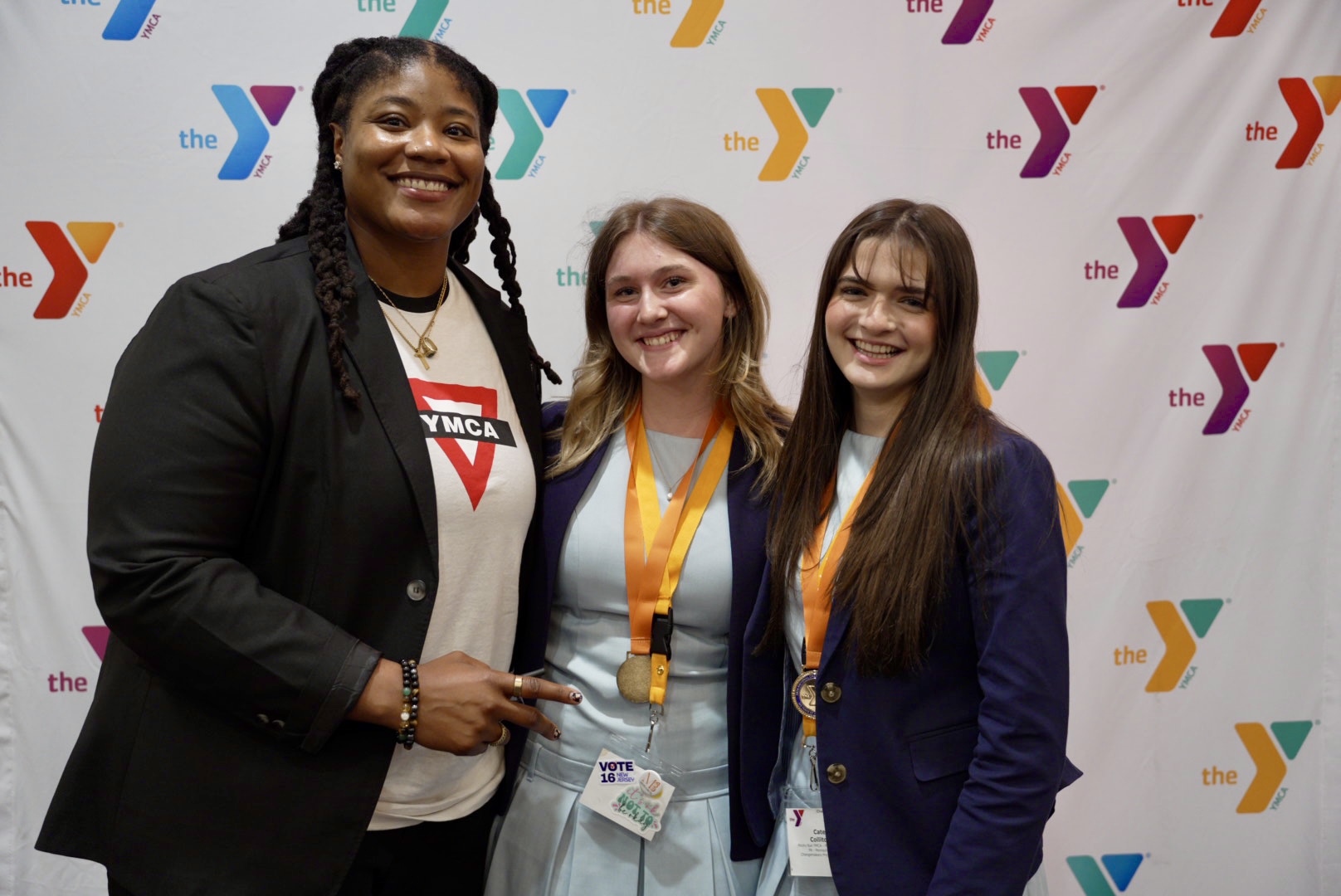 YMCA of the USA Director of Teen Strategy, E Mitchell, congratulates 2026 Changemakers Summit winners Teagan M. and Catherine C. (State YMCA of Philad
