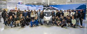 Students pose in front of aircraft at ICON Aircraft