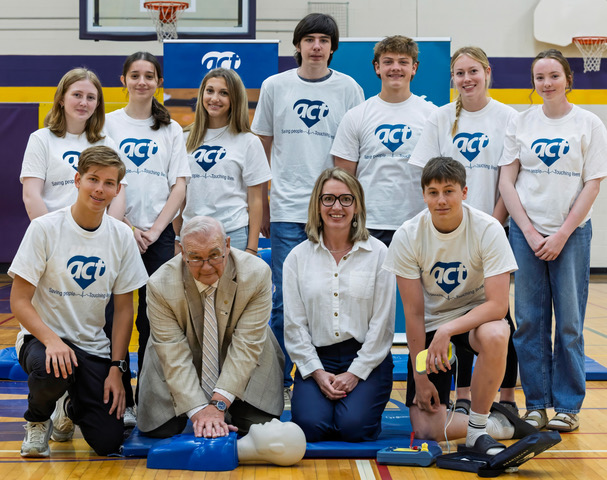 The ACT Foundation along with Doug Elmslie, Mayor of Kawartha Lakes and Janet Holt, Director of Health and Safety Field Support at Hydro One get a lesson in lifesaving from the students at I.E. Weldon Secondary School during the press event celebration of more than 25,000 students in the area being trained in CPR and how to use an AED through the ACT High School CPR and AED Program.