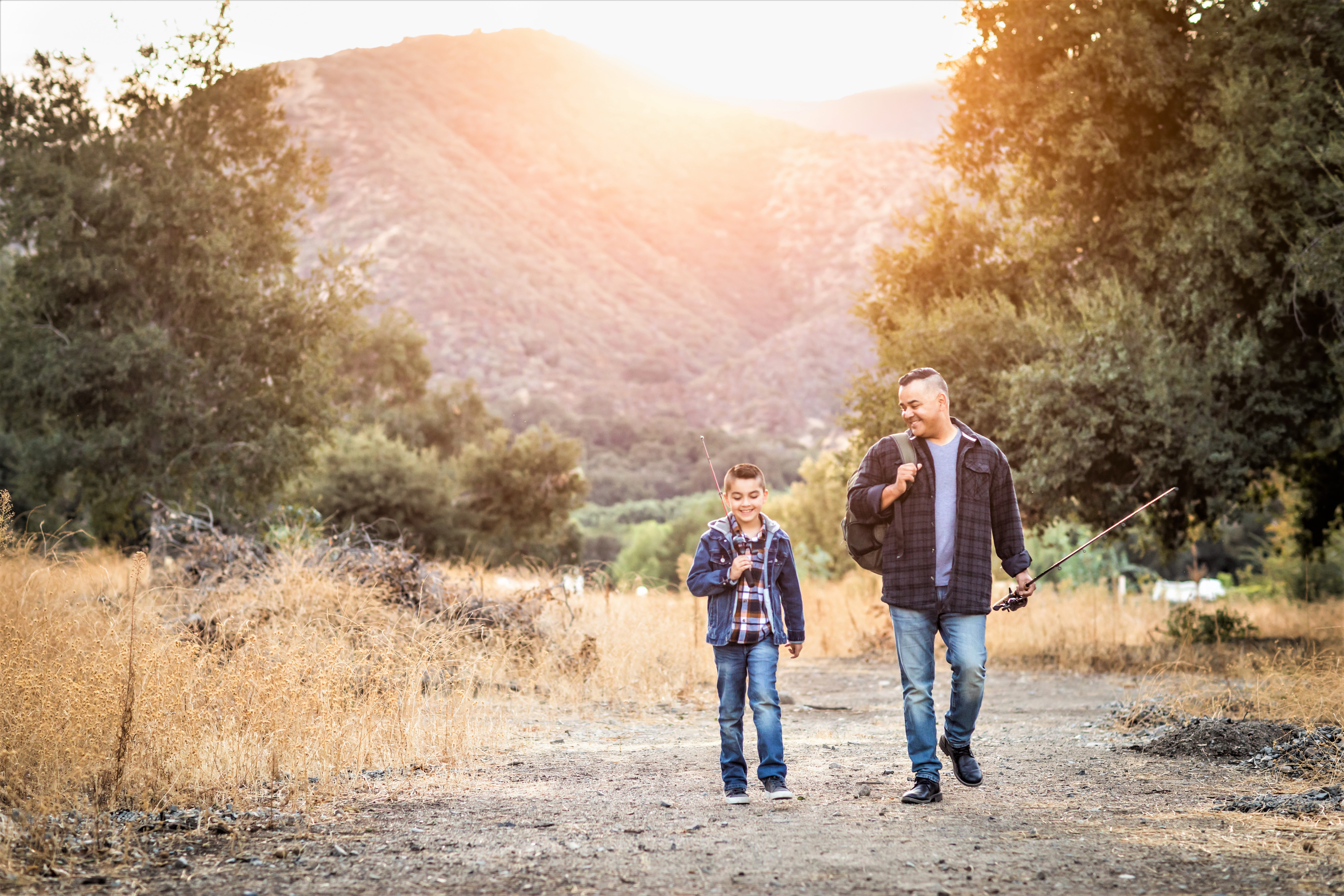 Father and son go fishing in the countryside. 