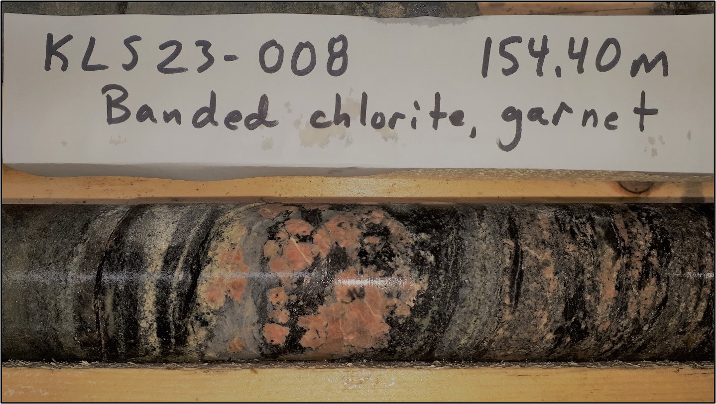 A photo of DDH KLS23-008 (154.4m depth): Banded chlorite, garnet
