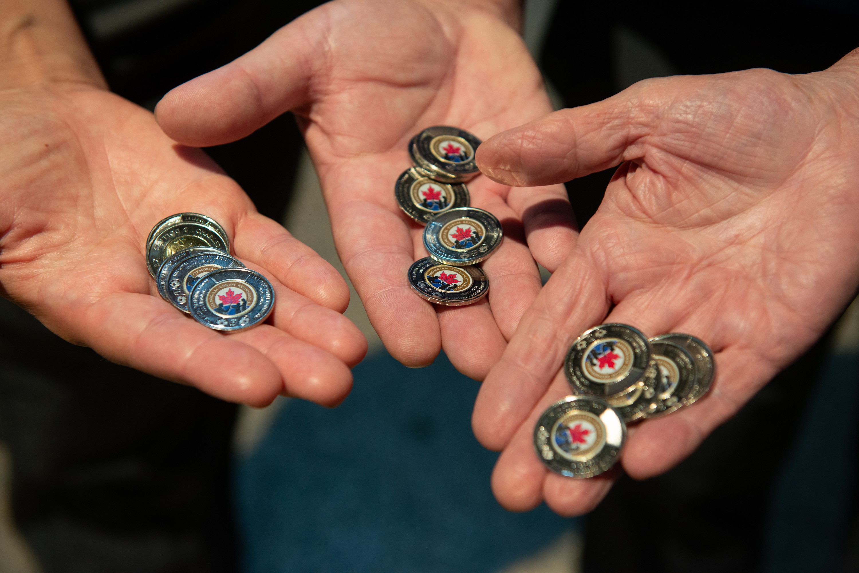 Handful of $2 coins marking Legion centenary