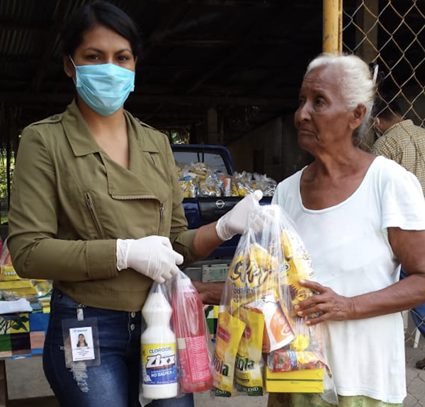 “Dinant’s social liaison staff in the Aguán donates food and disinfectants to local people”